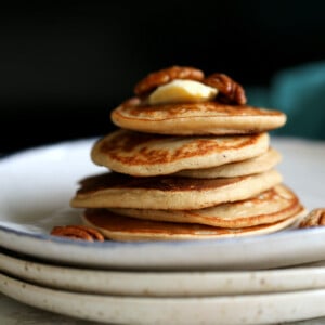 Banana Oat Pancakes Stacked on white plates