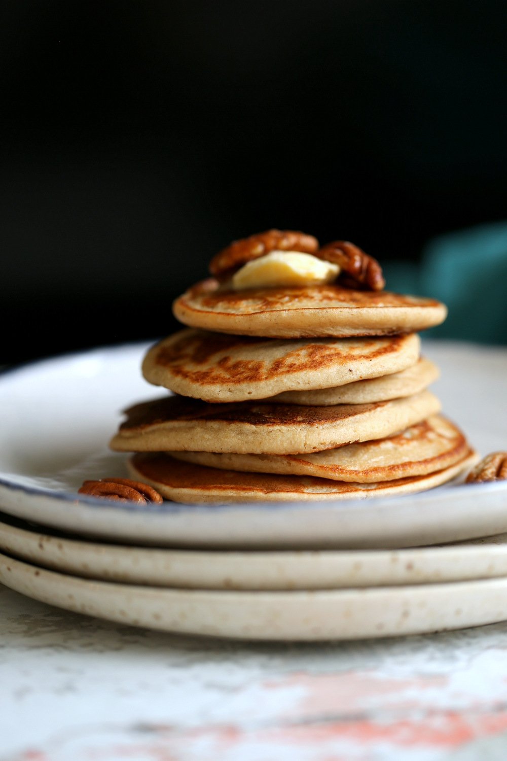 Vegan Banana Oat Pancakes Stacked on white plates