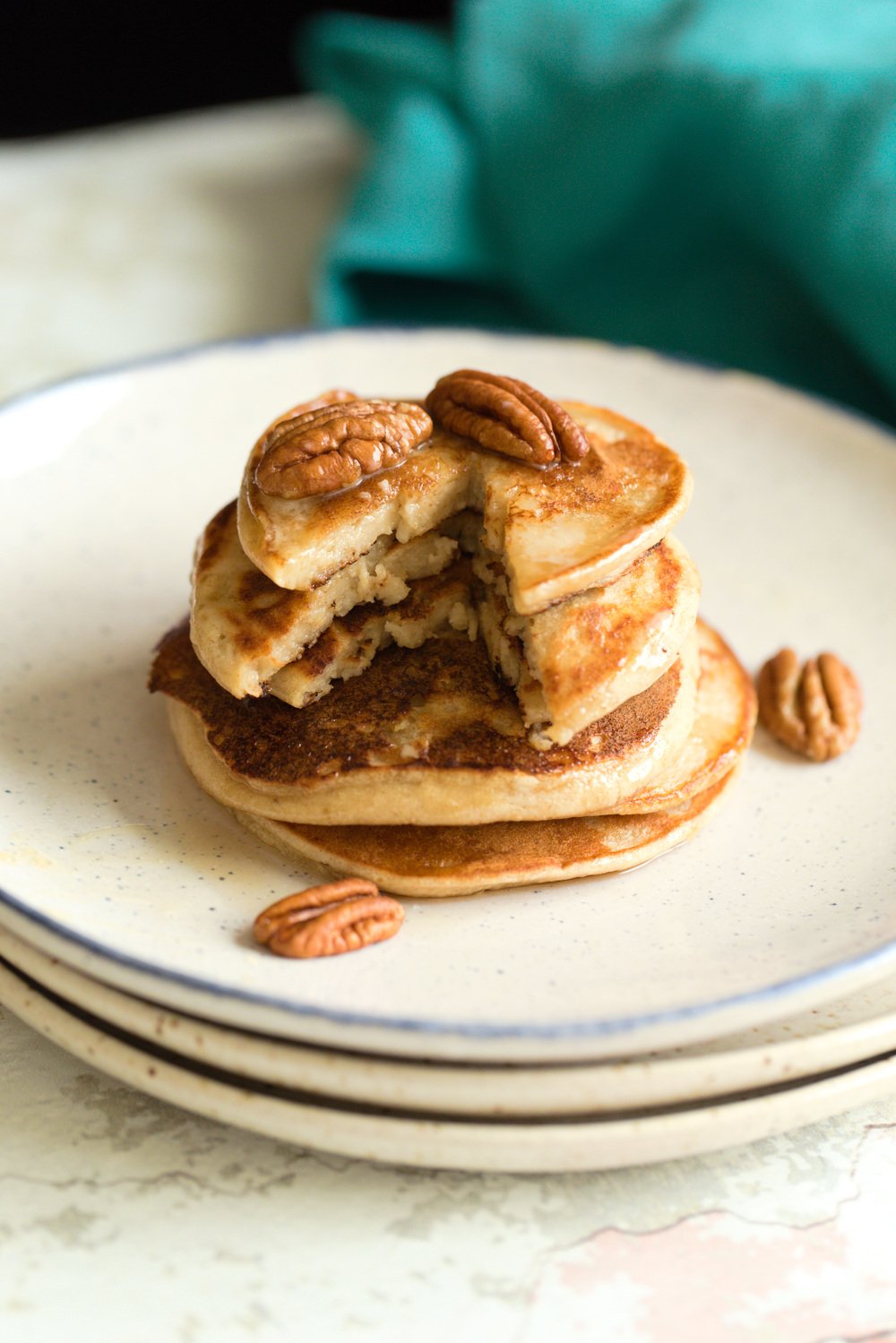 Vegan Banana Oat Pancakes Stacked on white plates