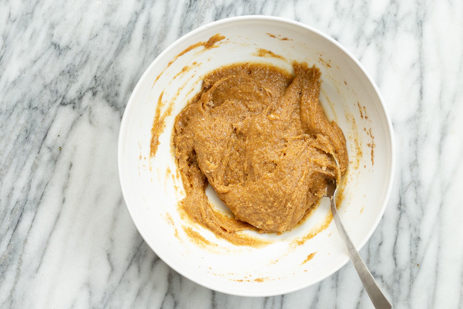 Dough for our Tahini Cookies in a white bowl