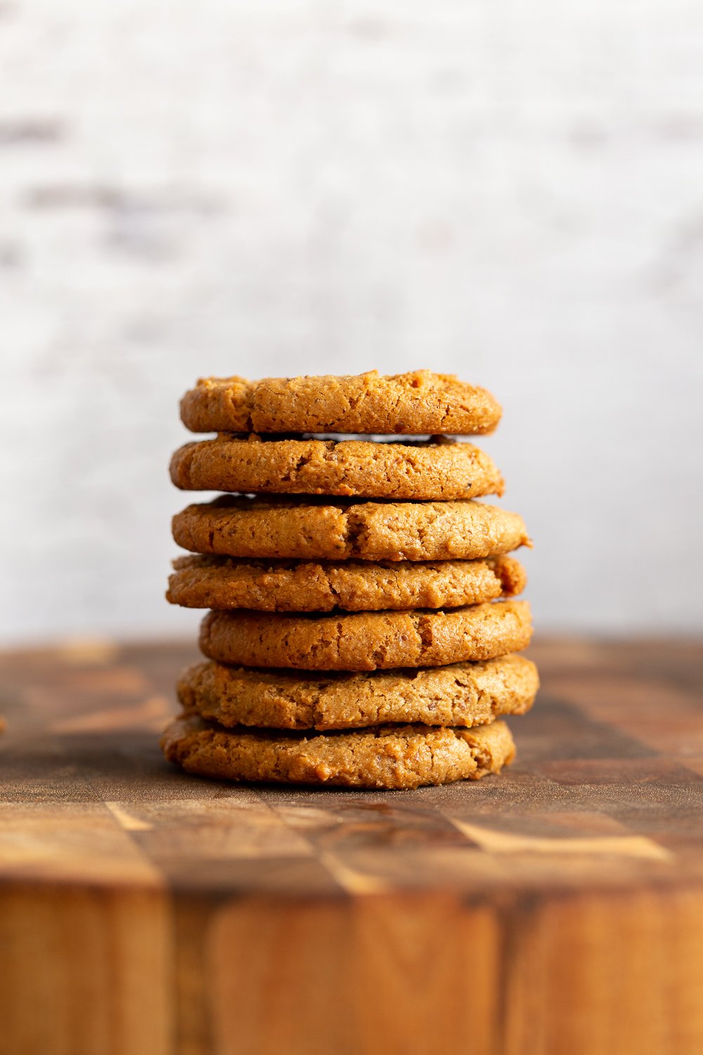 Our Chai Spice Tahini Cookies Nut free stacked on a wood board