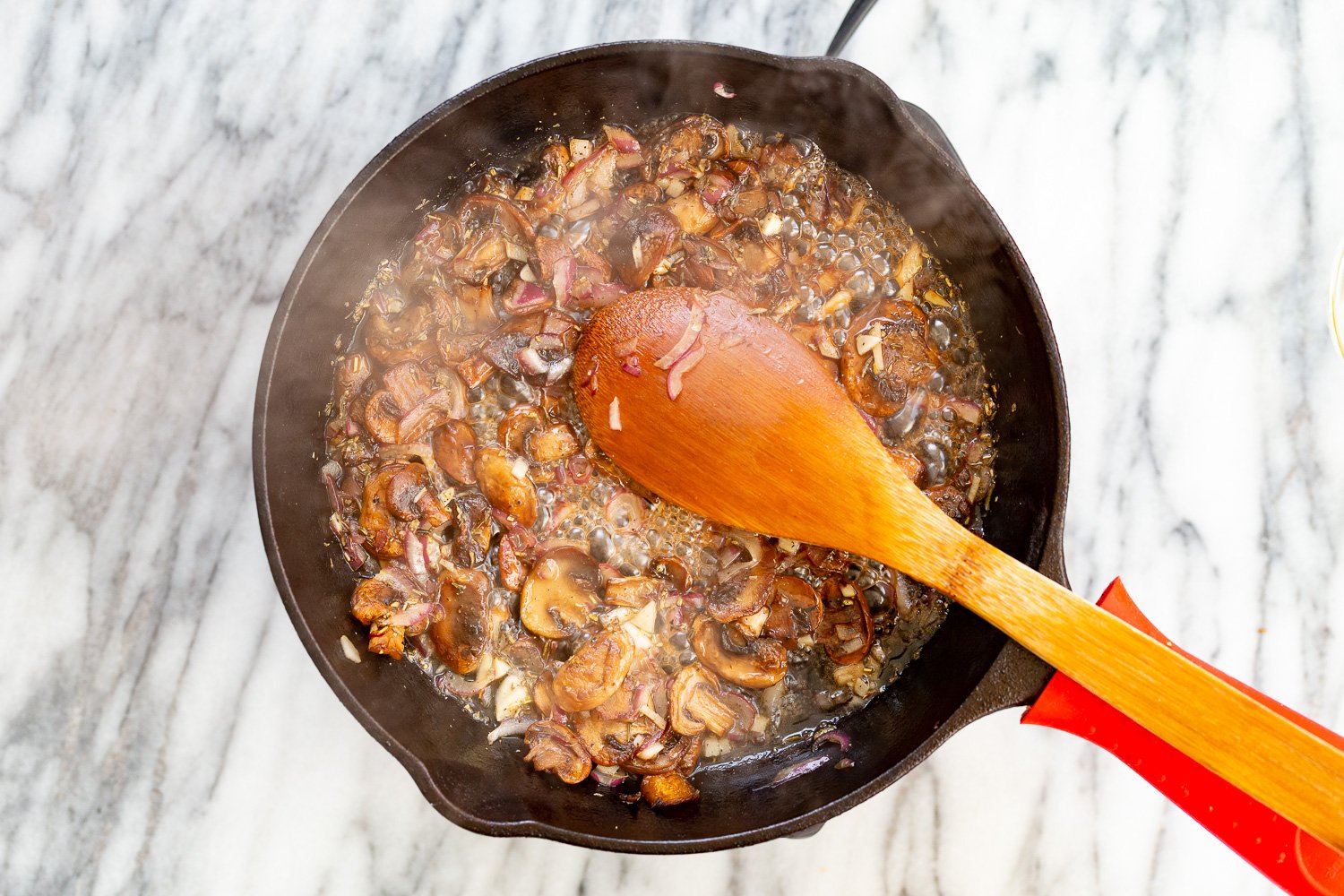 Mushrooms and wine in a cast iron skillet