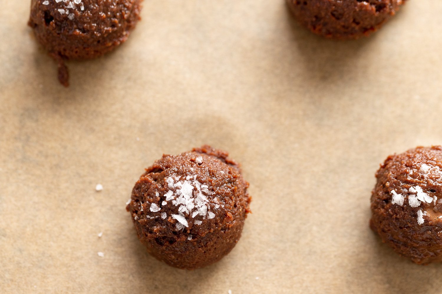 Vegan Brownie Cookie Dough scoop on parchment lined sheet