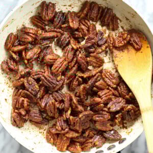 Sticky Pecans in a white skillet