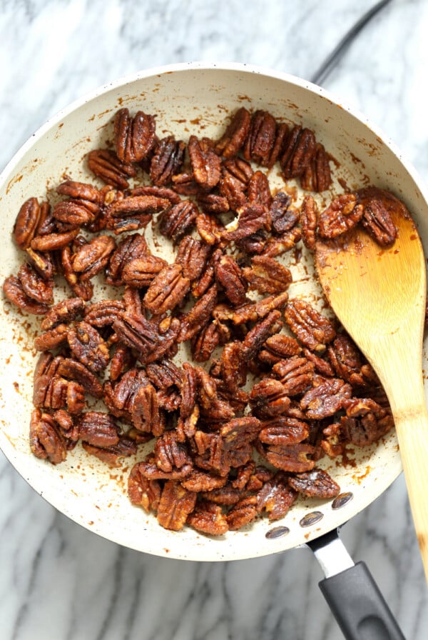 Sticky Pecans in a white skillet