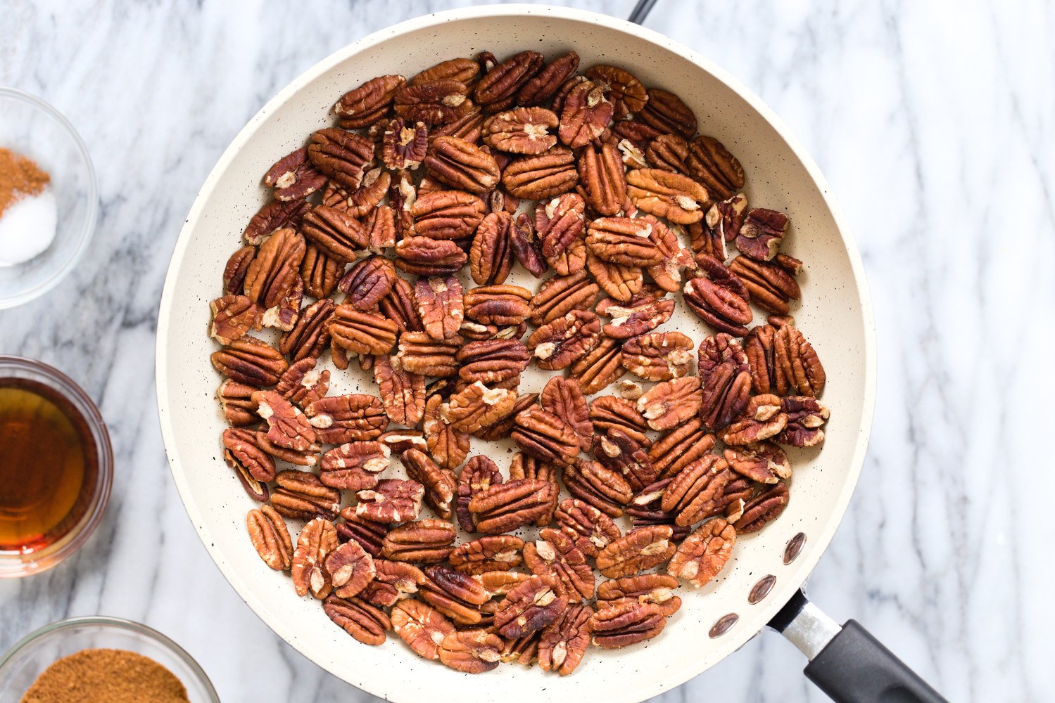 Toasted Pecans in a white skillet