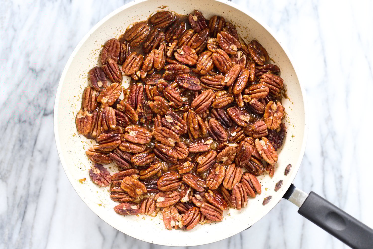 Toasted Pecans in a white skillet