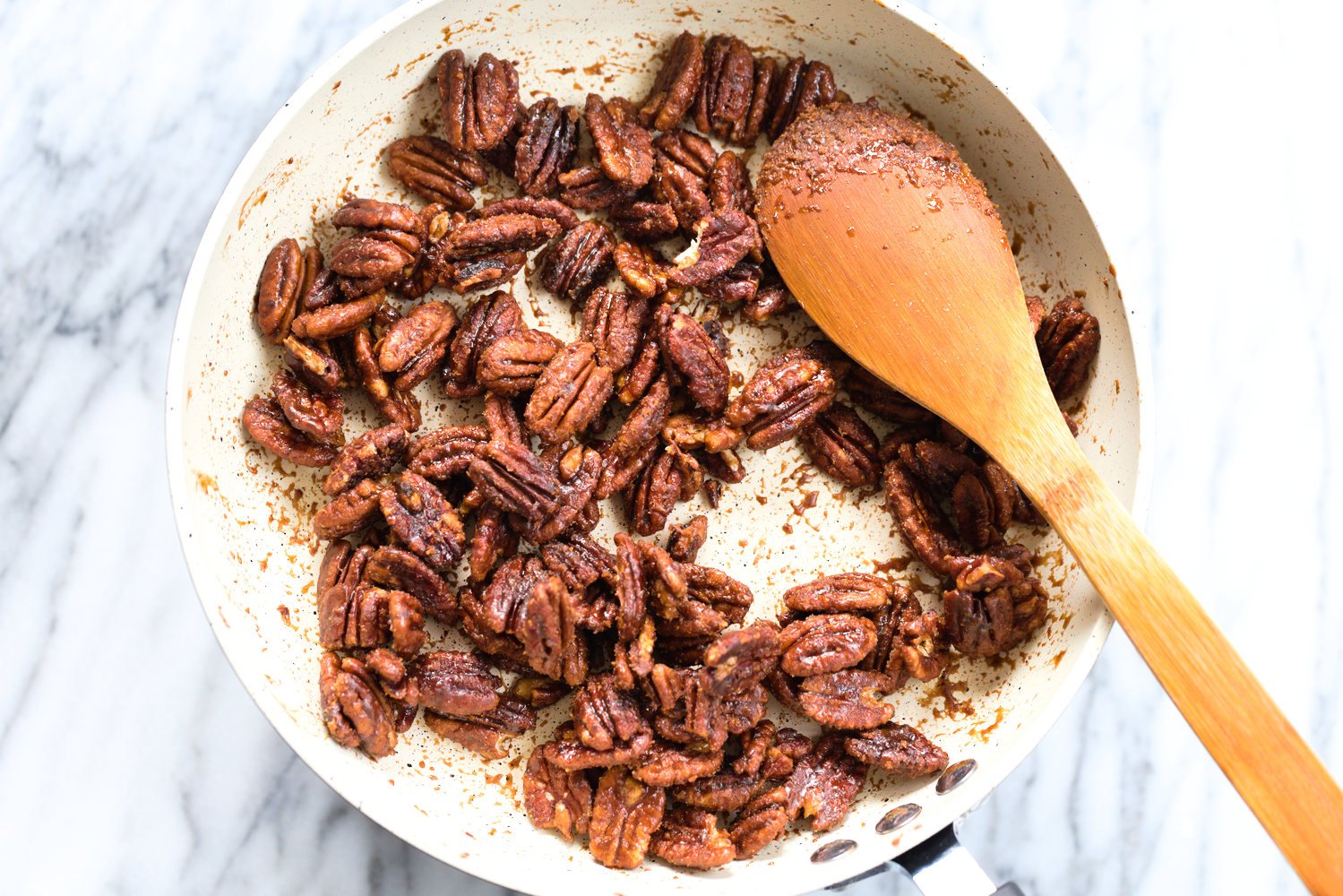 Toasted Candied Pecans in a white skillet