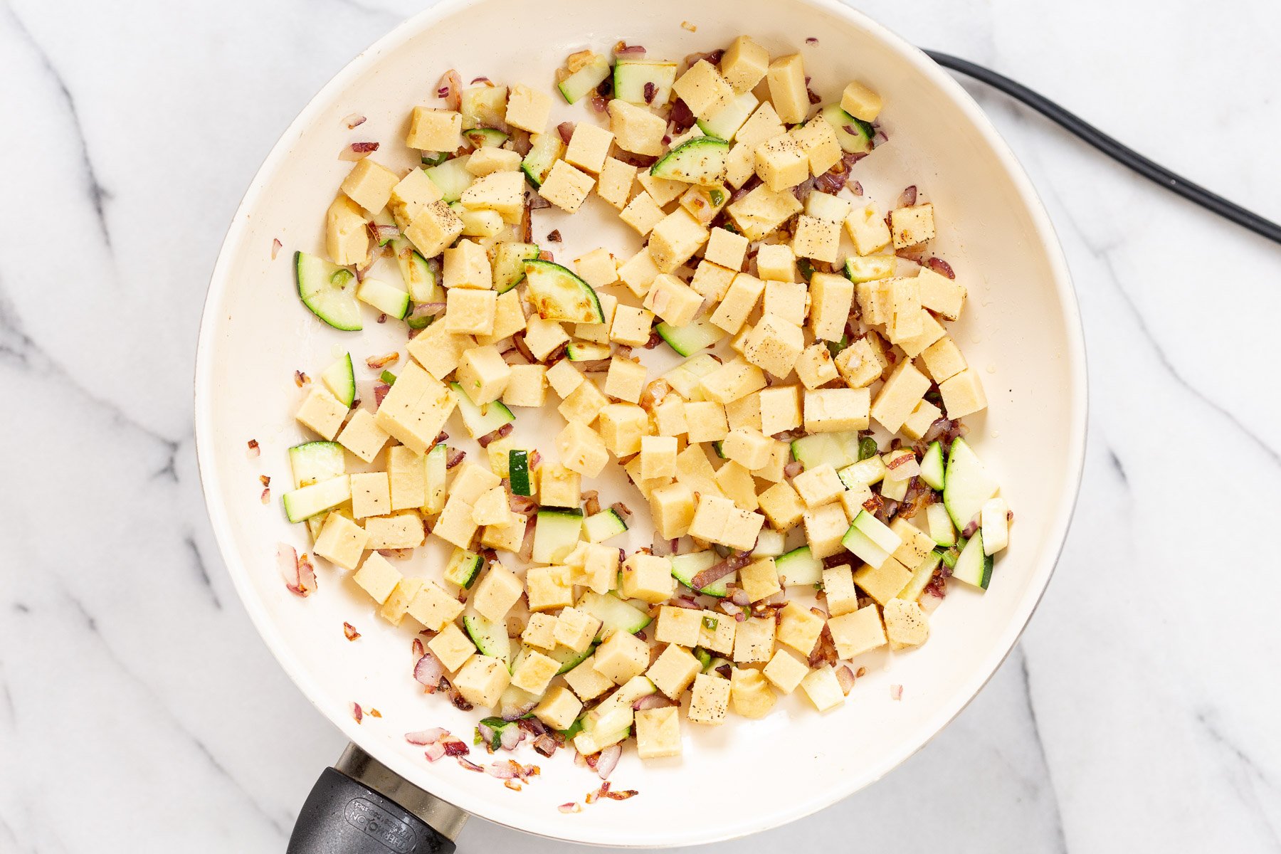 Cubes Chickpea Tofu on a white skillet