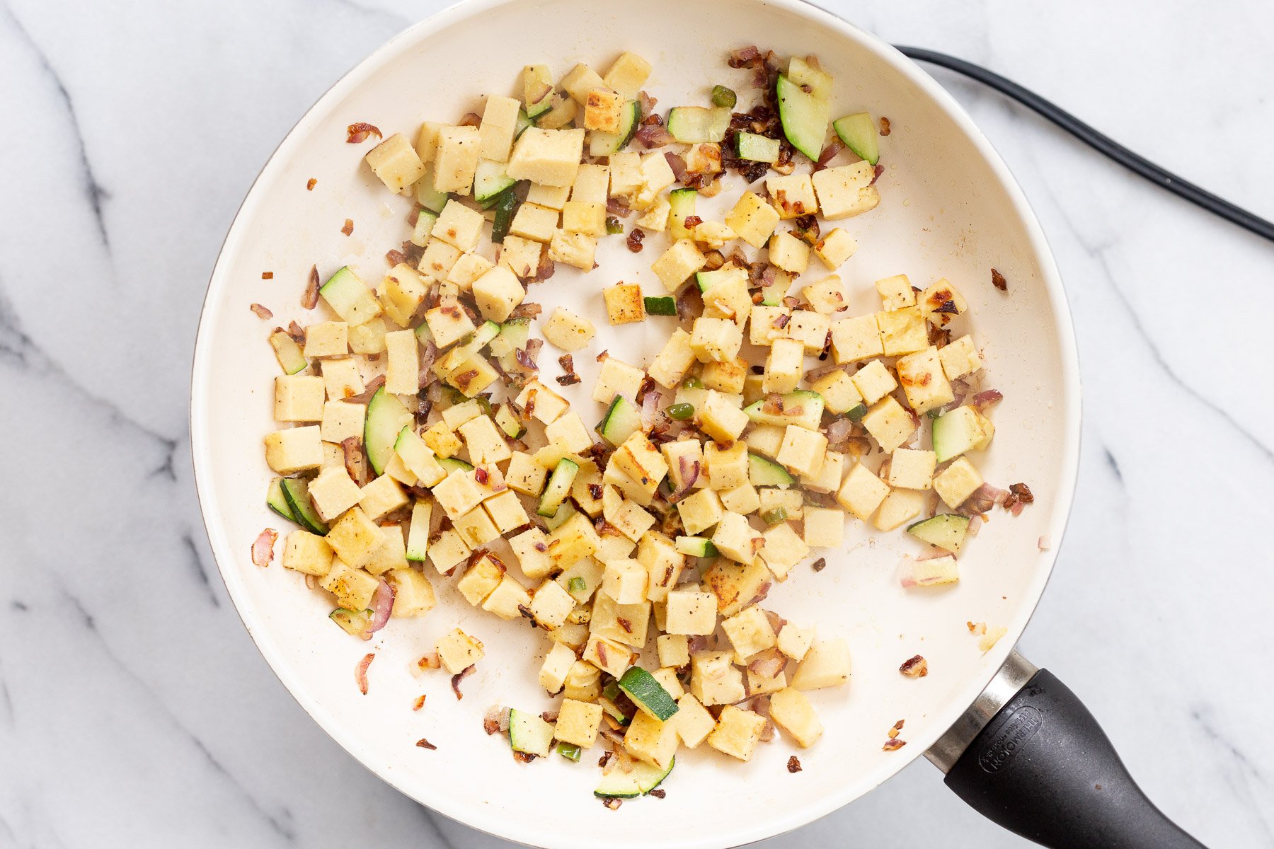 Cubes Chickpea Tofu on a white skillet