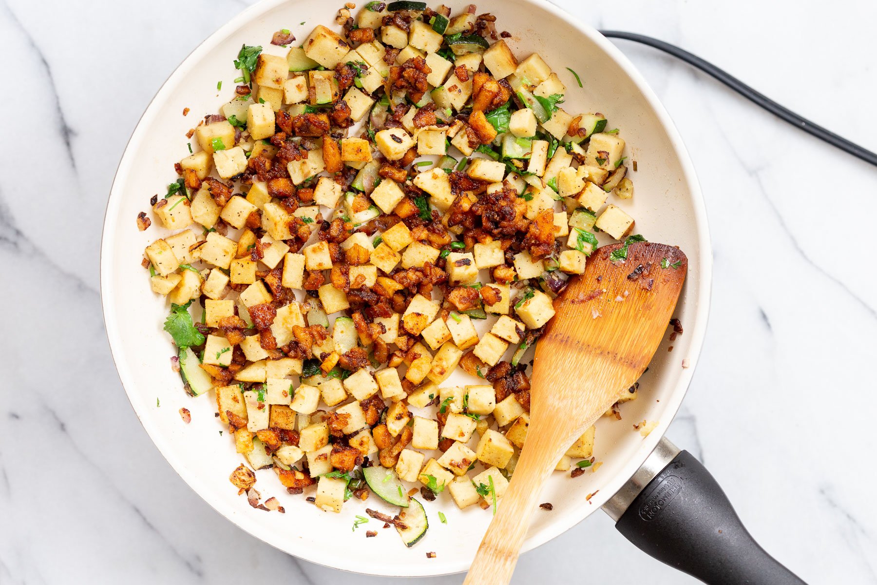 Chickpea Tofu Breakfast Scramble on a white skillet