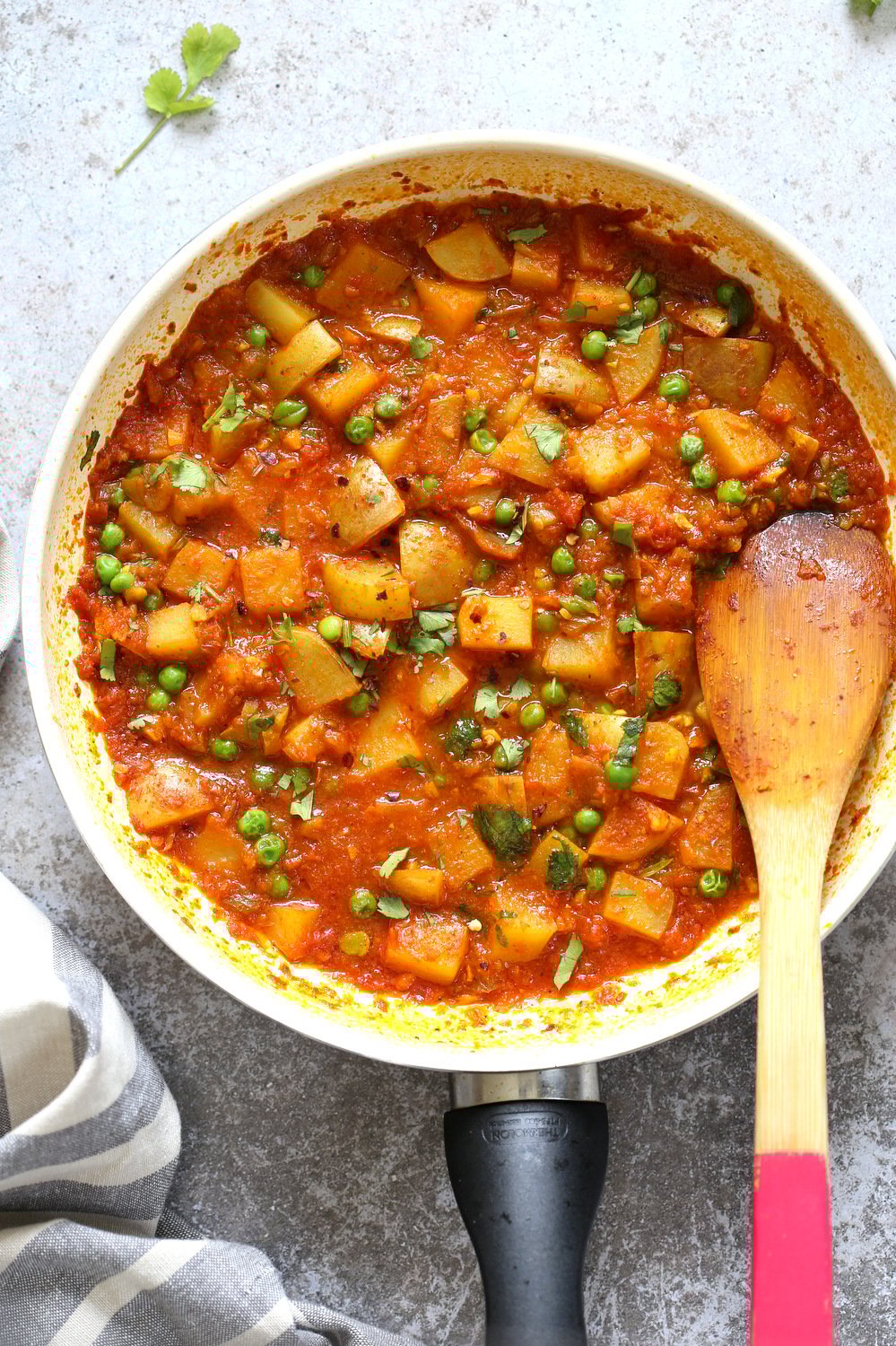 aloo matar overhead shot of Vegan Aloo Matar with potatoes and peas in a skillet
