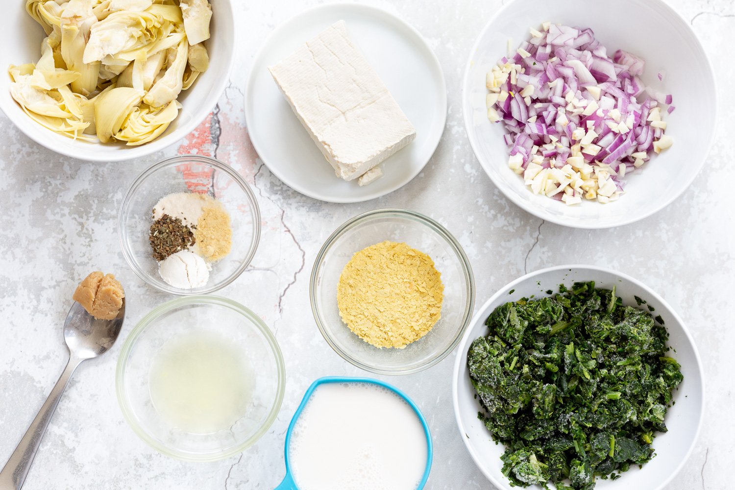 spinach pasta recipe  overhead shot of ingredients needed for making spinach artichoke pasta bake