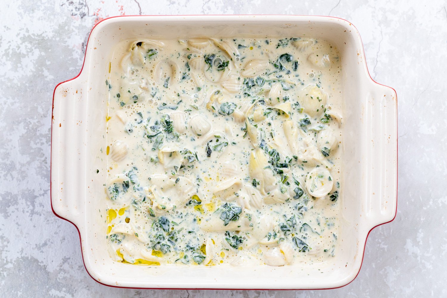 spinach pasta recipe spinach artichoke pasta bake ready to go in the oven