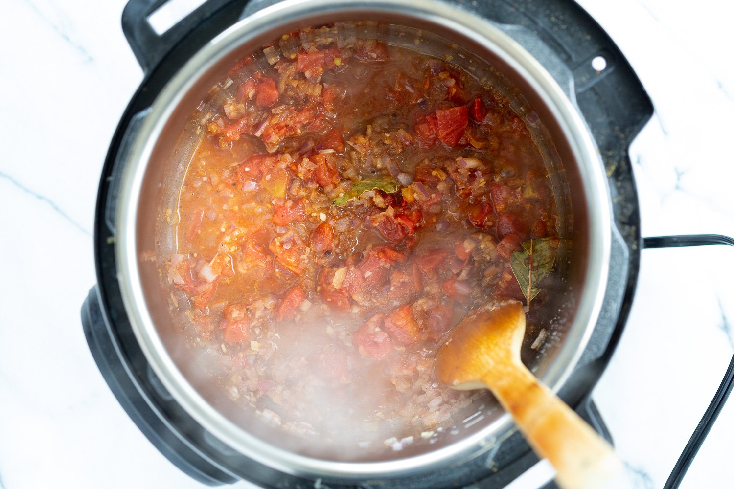 Vegan Black Beans Soup  onion, garlic, spices and tomatoes simmering in an Instant Pot