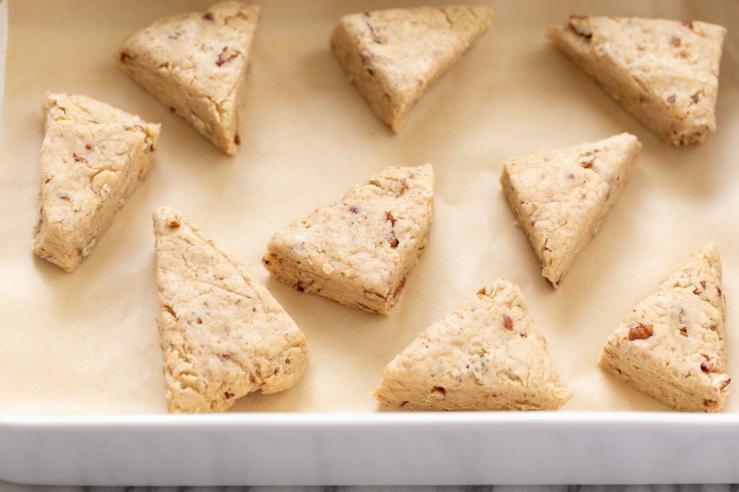 banana scones vegan banana scones on a cookie sheet lined with parchment paper
