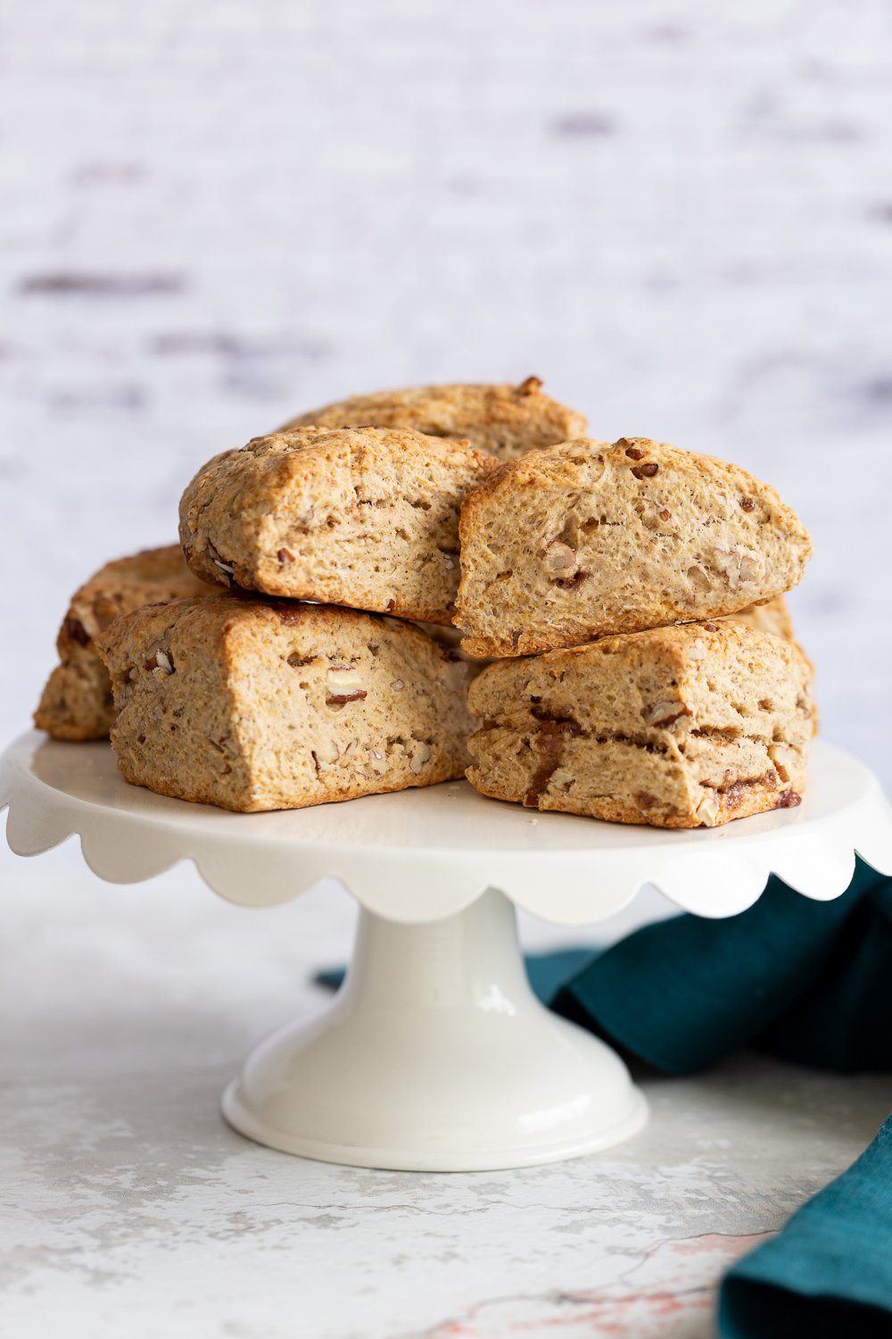 banana scones side view of vegan banana scones on a white cake stand