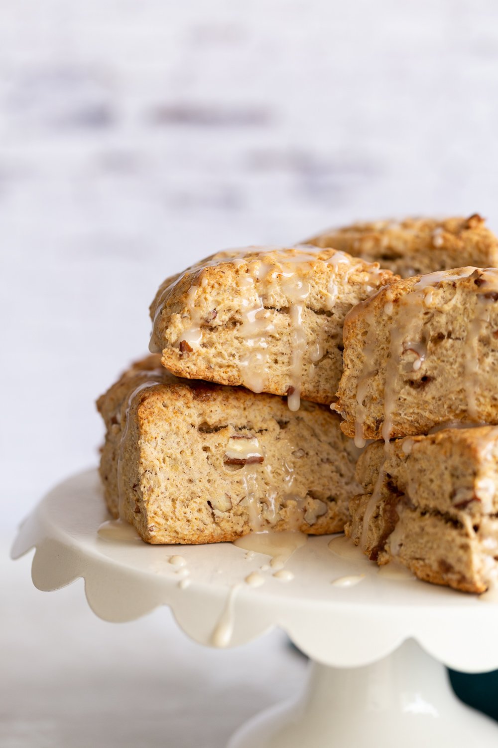 banana scones  close up side view of vegan banana scones on a white cake stand