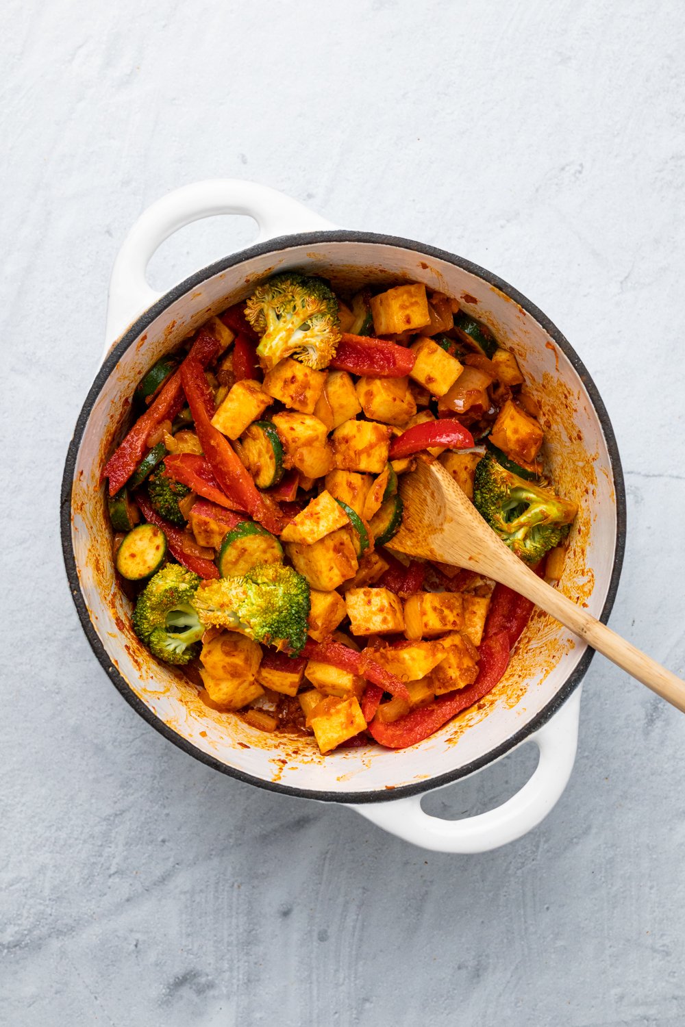 sweet potato curry  vegetables and potatoes being sauteed with Thai red curry paste to make vegan curry