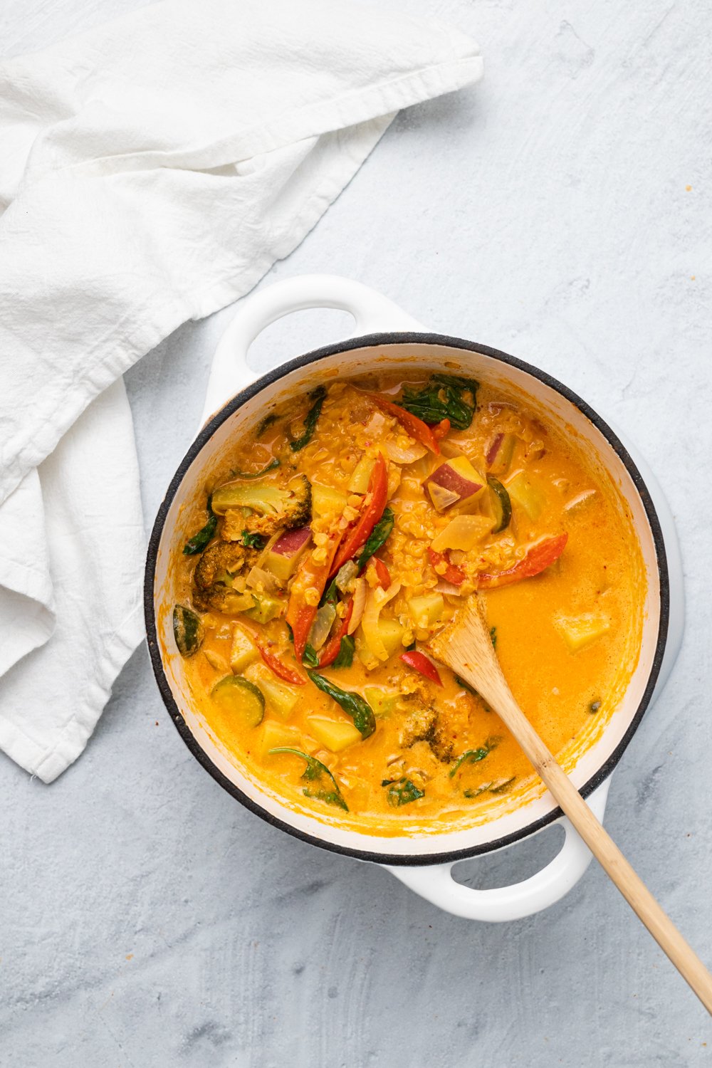 sweet potato curry  overhead shot of a white ceramic pot filled with vegan red lentil sweet potato curry