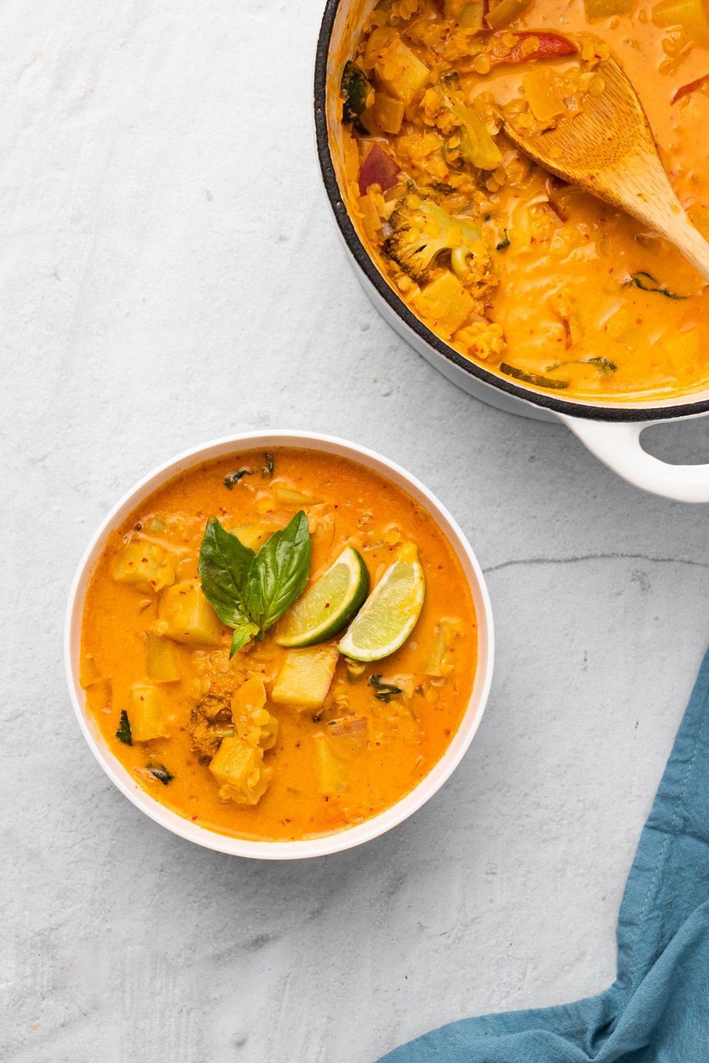 sweet potato curry a bowl of vegan Thai sweet potato curry with red lentils next to a pot