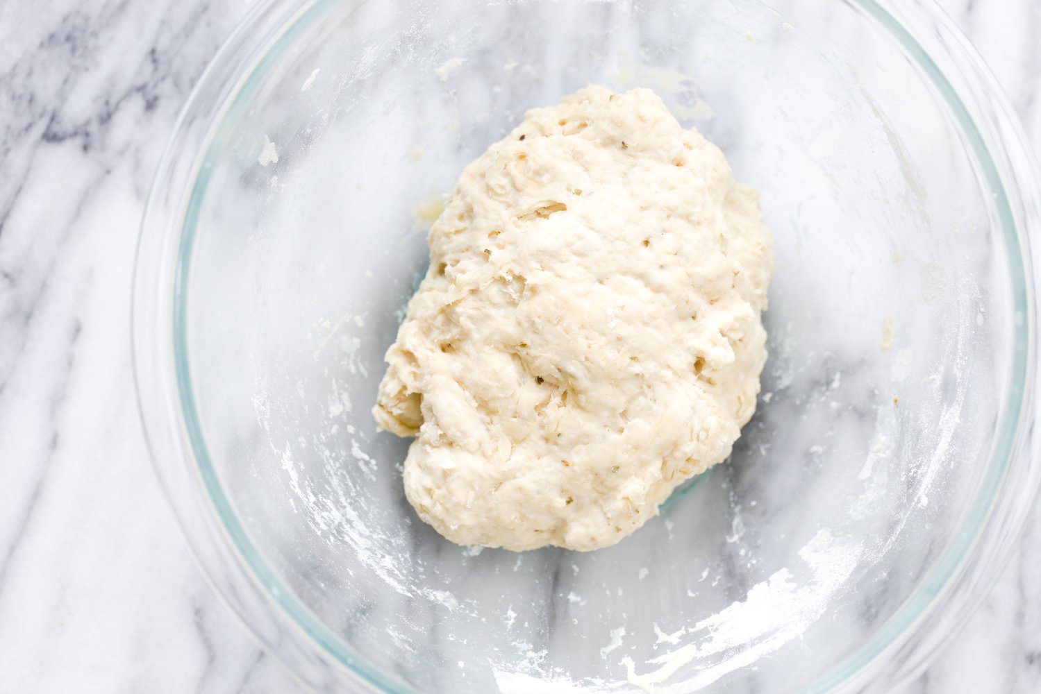 no yeast pizza dough  vegan yeast-free pizza dough being mixed in a glass bowl