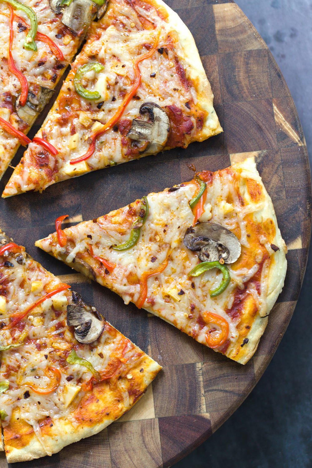 no yeast pizza dough overhead shot of a freshly baked vegan pizza cut into wedges