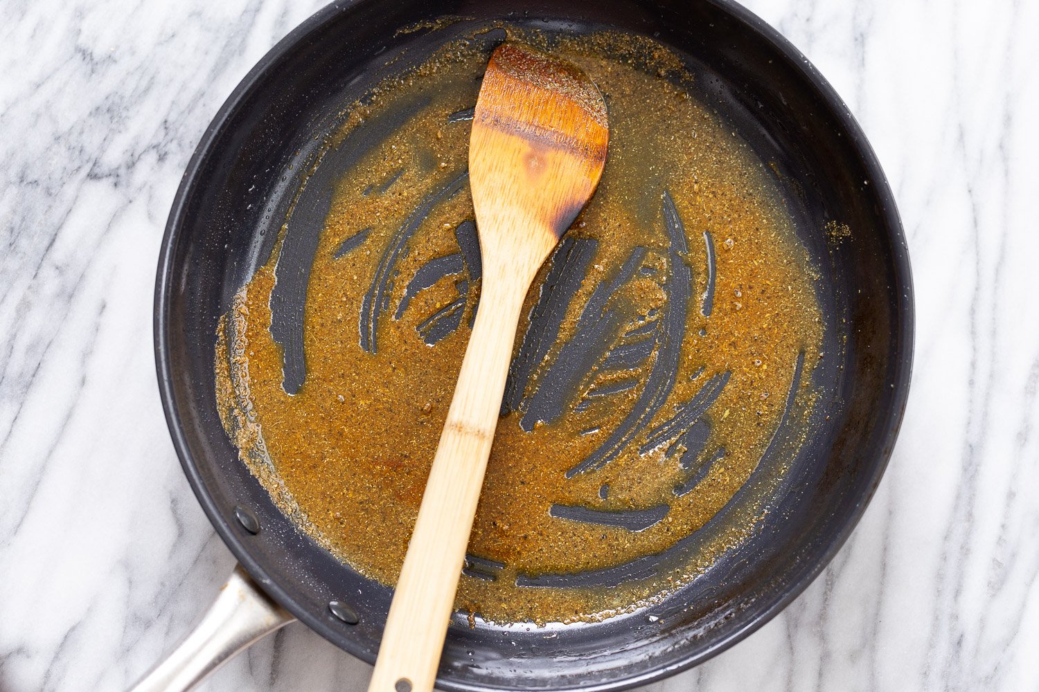 tofu in sauce spices being fried in hot oil