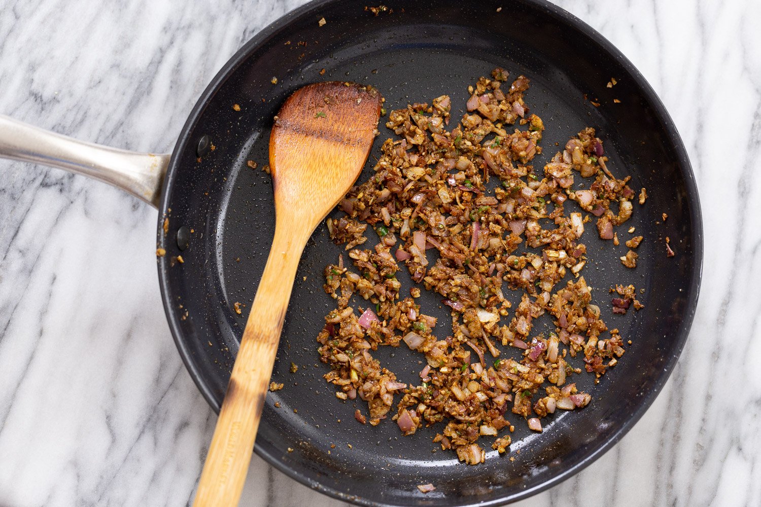 tofu in sauce onions, ginger and chili being stir-fried with spices and oil to make tofu in black pepper sauce