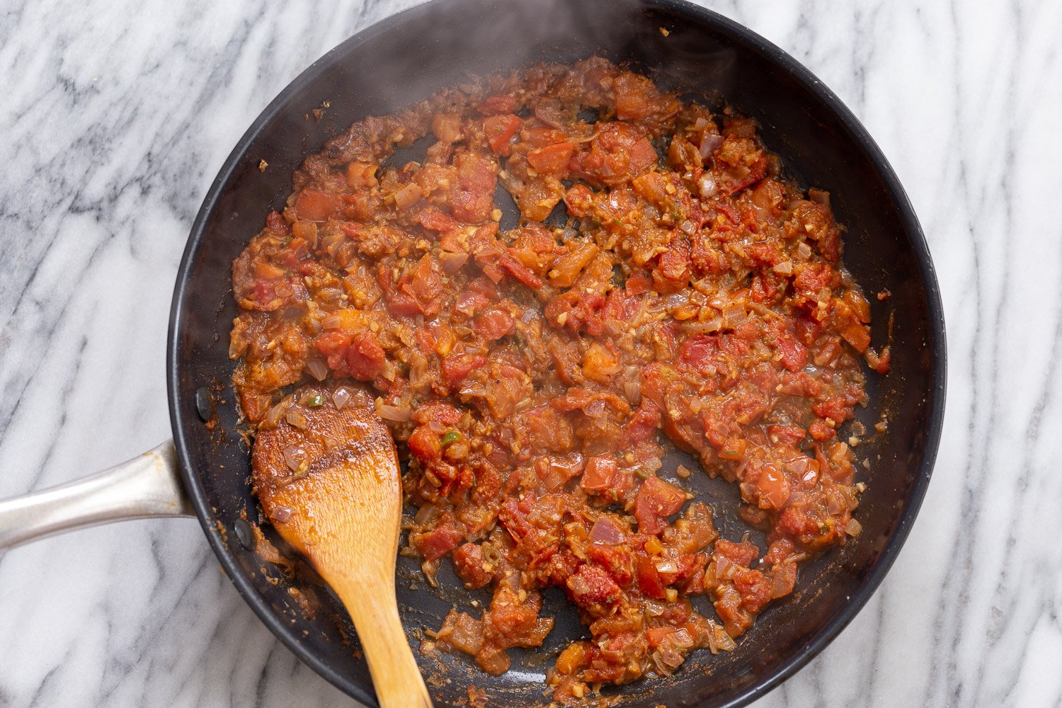 tofu in sauce tomatoes gravy in a black skillet