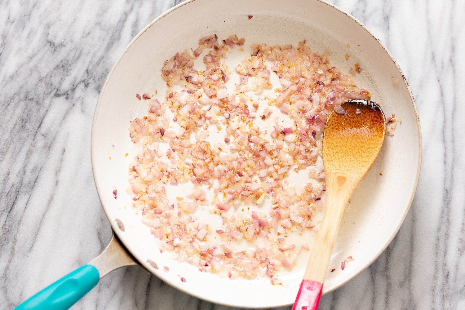 peanut stew diced onion sauteeing in a frying pan for making peanut stew