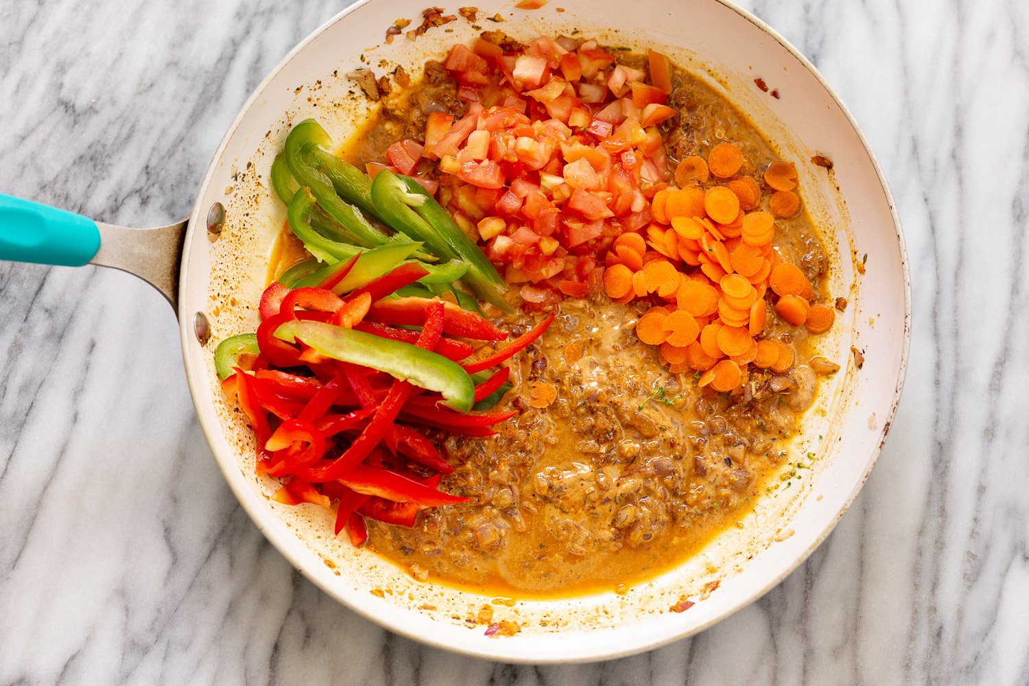 peanut stew chopped vegetables being added to kidney bean peanut stew