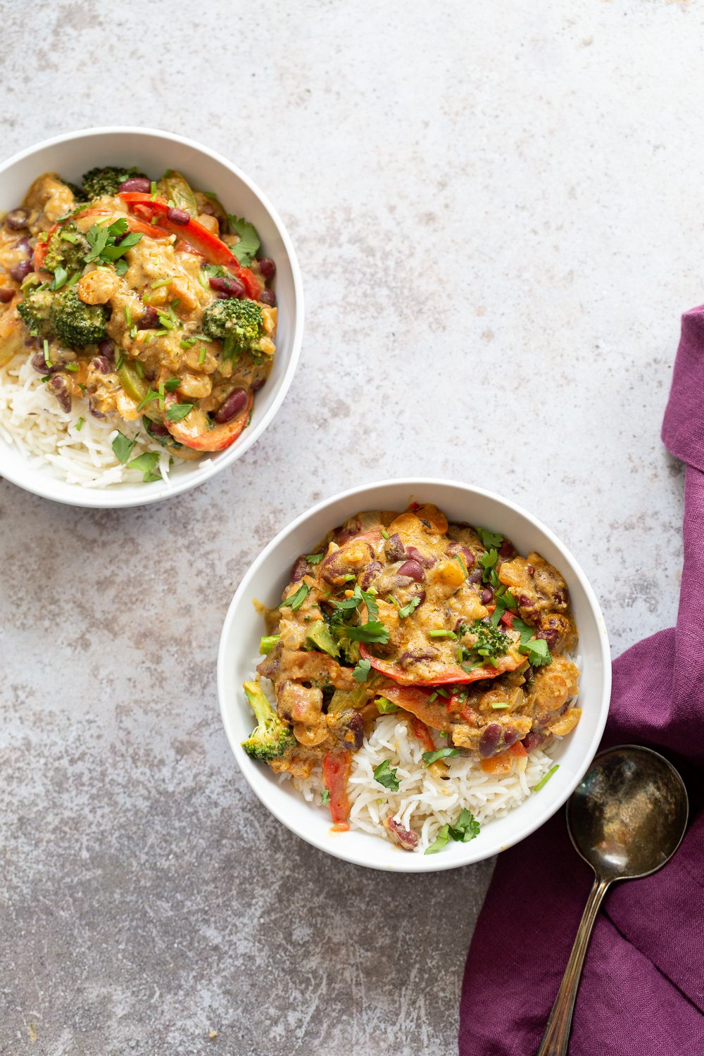 Peanut Stew overhead shot of two bowl with vegan coconut milk based Peanut Stew served with rice