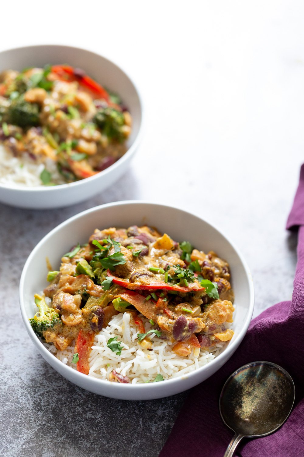 Peanut Stew two bowls of vegan creamy coconut mild and kidney bean Peanut Stew served with rice