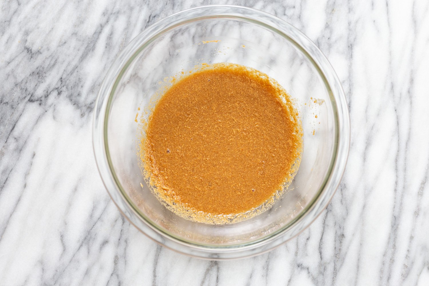 snickers recipe  melted peanut butter heated with plant-based milk in a small glass bowl