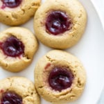 overhead shot of a plate of vegan peanut butter jelly thumbprint cookies
