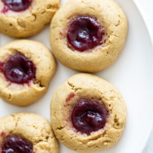 overhead shot of a plate of vegan peanut butter jelly thumbprint cookies