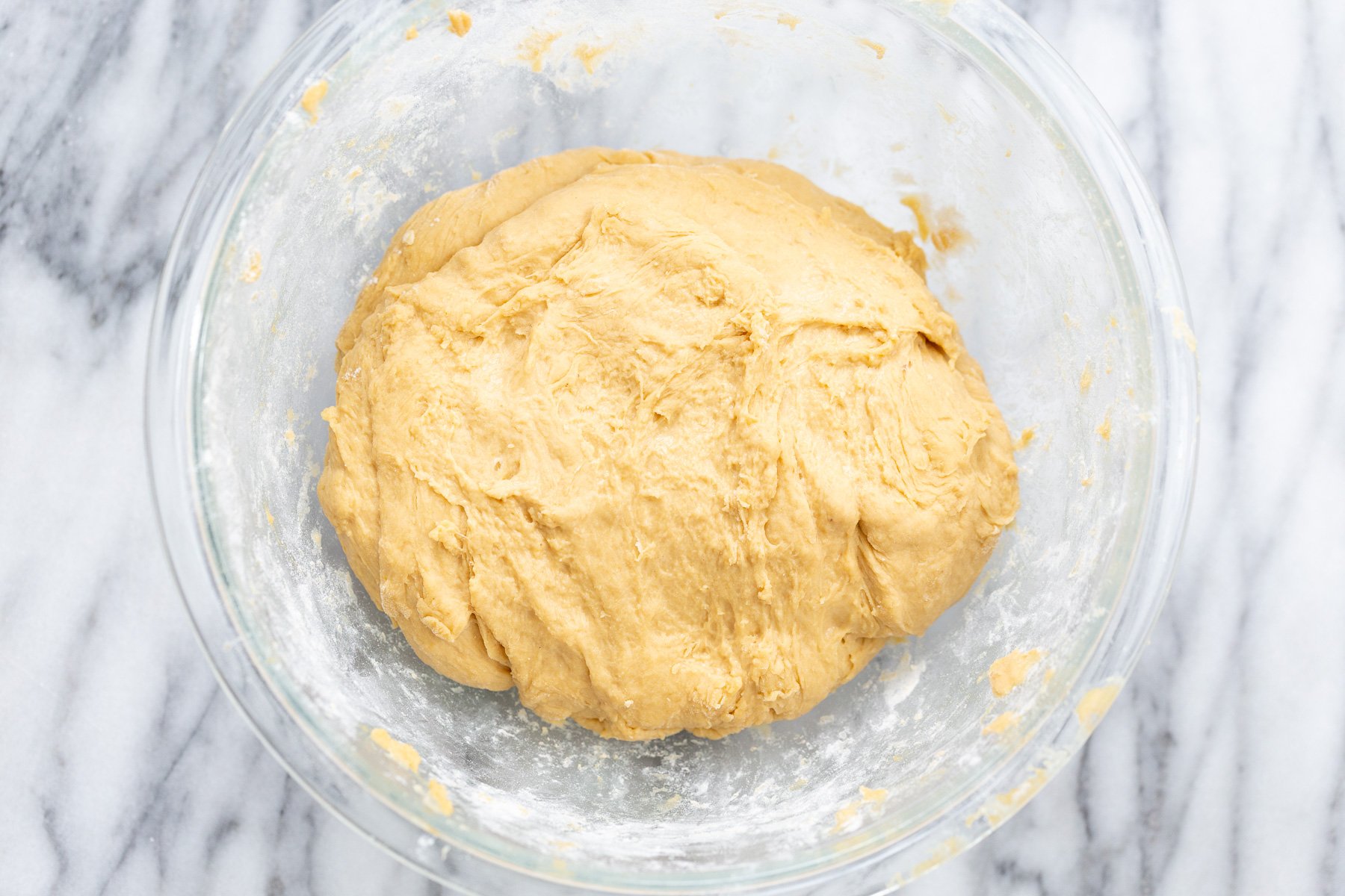 no yeast cinnamon rolls  overhead shot no yeast cinnamon roll dough in glass bowl