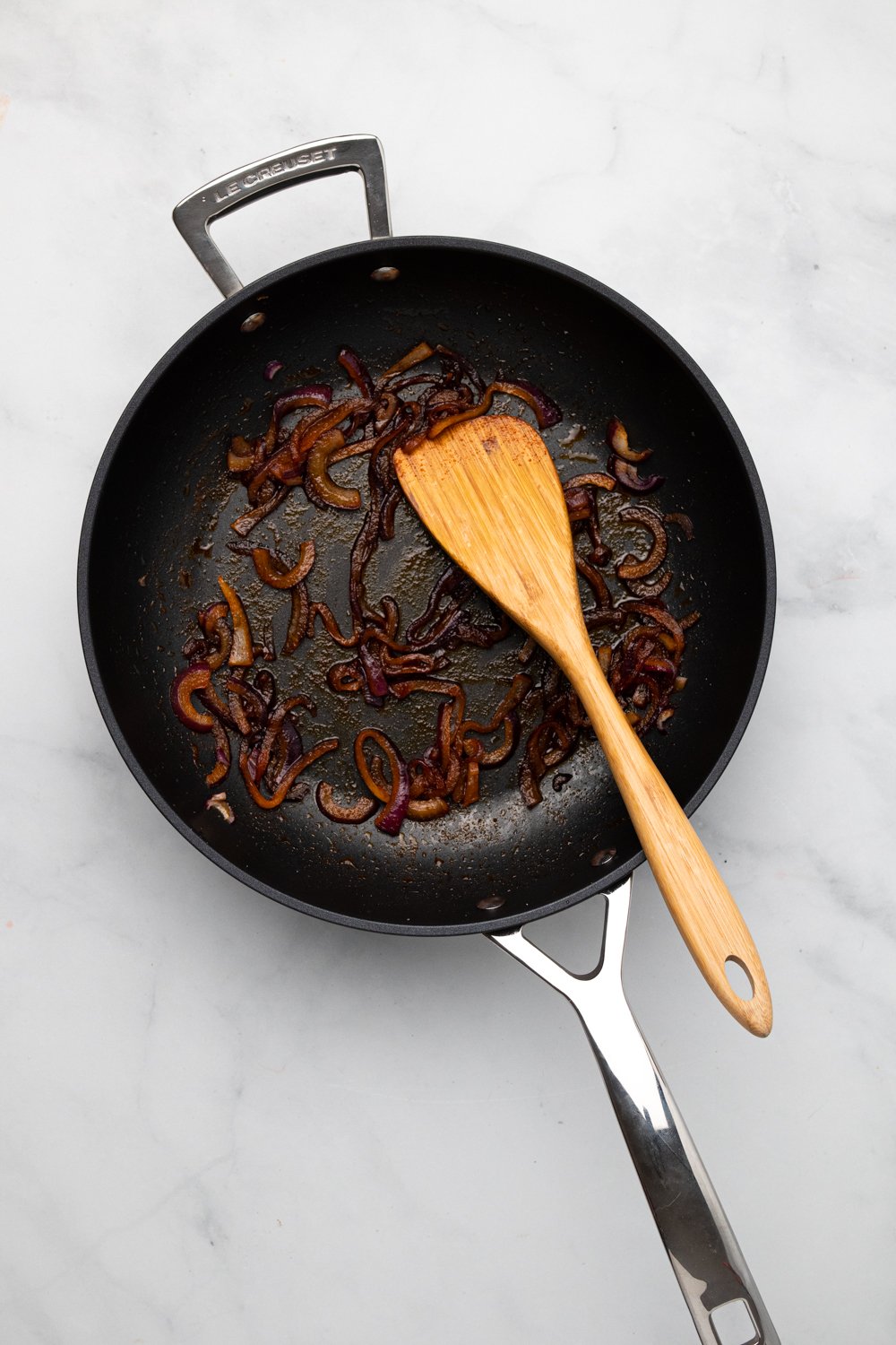 chickpea burger  overhead shot of caramelized onion in a black frying pan