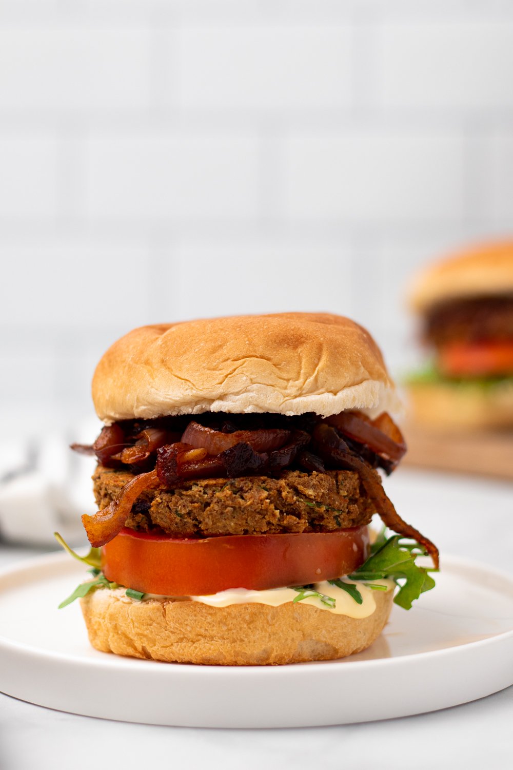chickpea burger  side view of a vegan Middle Eastern Za'atar Spiced Chickpea Burger on a white plate