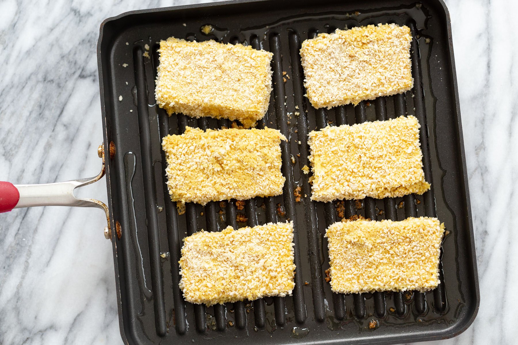 katsu curry  breaded tofu slices being fried in a pan