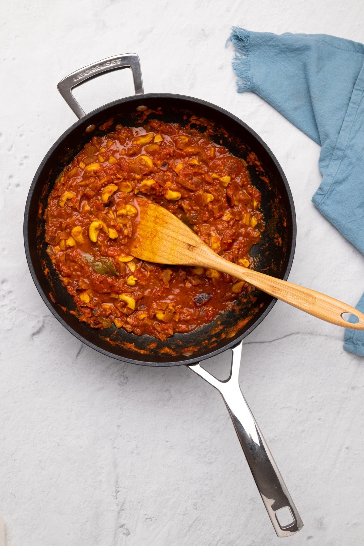 vegan malai kofta overhead shot of vegan malai kofta gravy in a black skillet