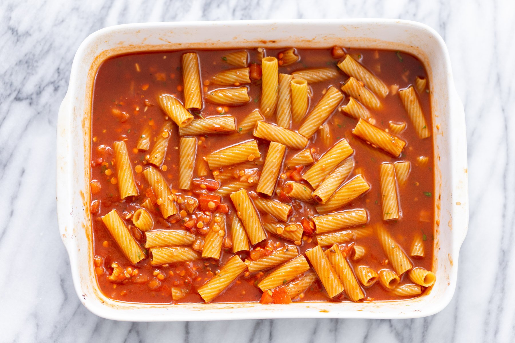 baked rigatoni ingredients for making baked vegan rigatoni tossed in a casserole dish