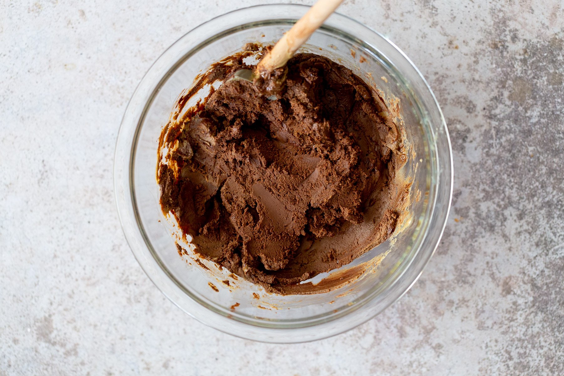 chocolate fudge recipe vegan fudge batter being mixed in a glass bowl