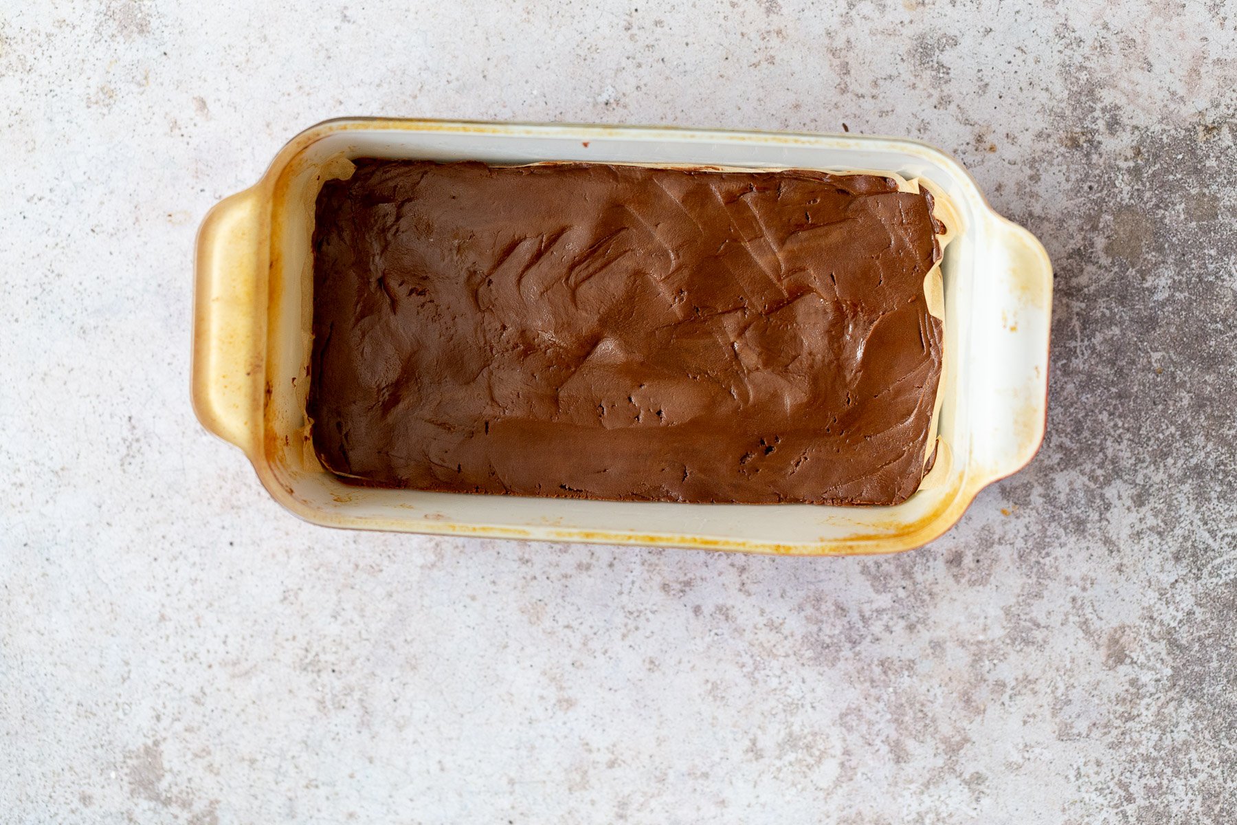 chocolate fudge recipe vegan chocolate fudge in a white loaf pan ready to be chilled