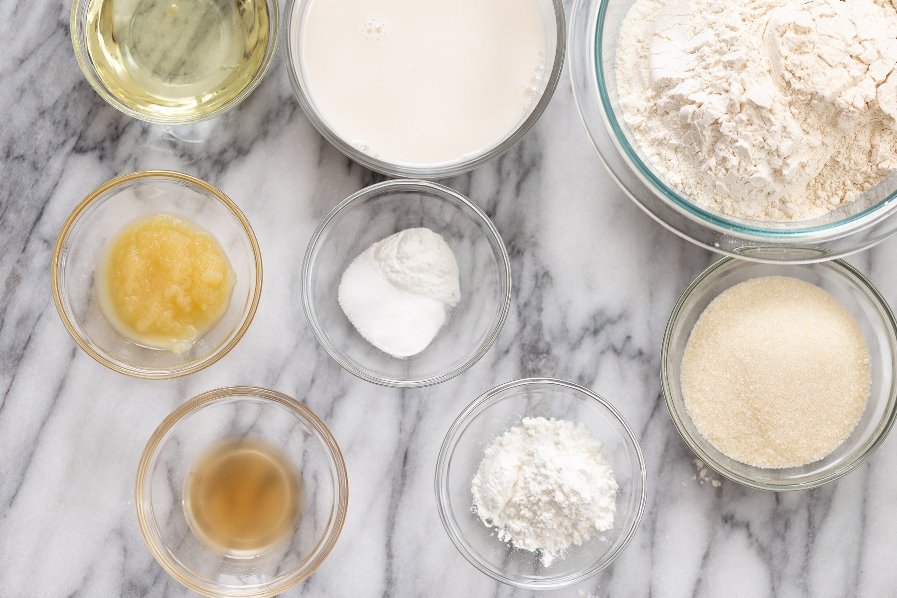 ingredients for making vegan white cake on a marble kitchen counter 
