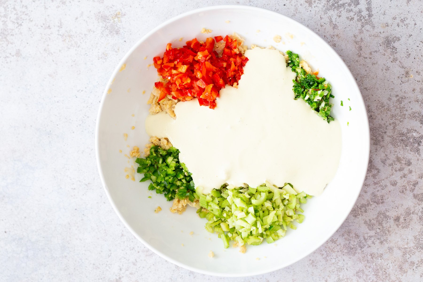 chickpea salad sandwich  creamy dairy-free tofu dip being added to chickpea salad ingredients