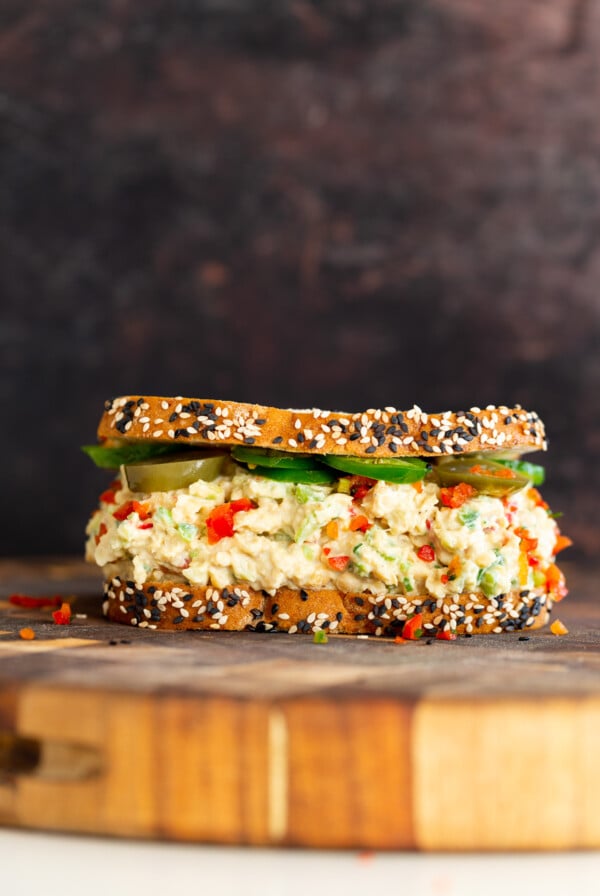 jalapeño popper chickpea salad sandwich on a chopping board