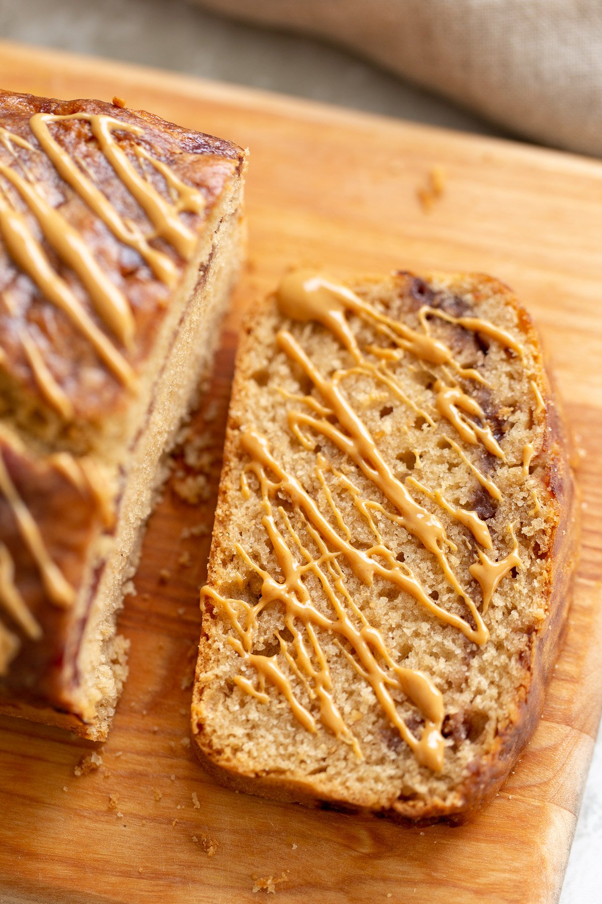 peanut butter and jelly cake  a slice of vegan peanut butter and jelly loaf cake drizzled with peanut butter