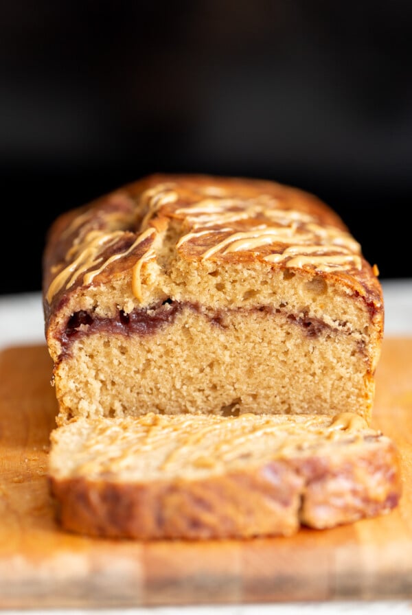 a sliced peanut butter and jelly cake on a cutting board